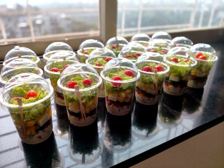 Mini Nutri Salad Glasses lined up on a window counter